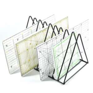 a black triangular divider with multiplle dividing slots and pattern makers in those slots